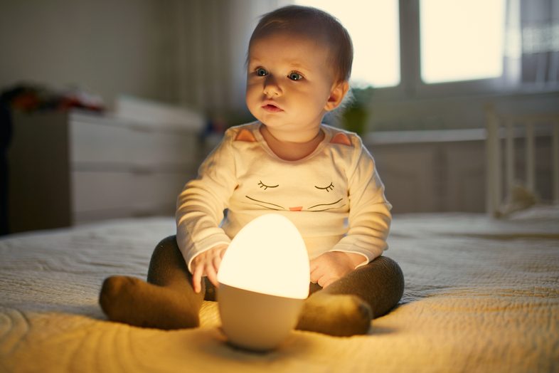 baby on bed with light